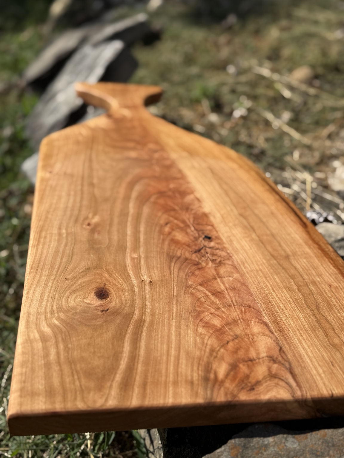Close-up view of the natural grain on the cherry charcuterie board