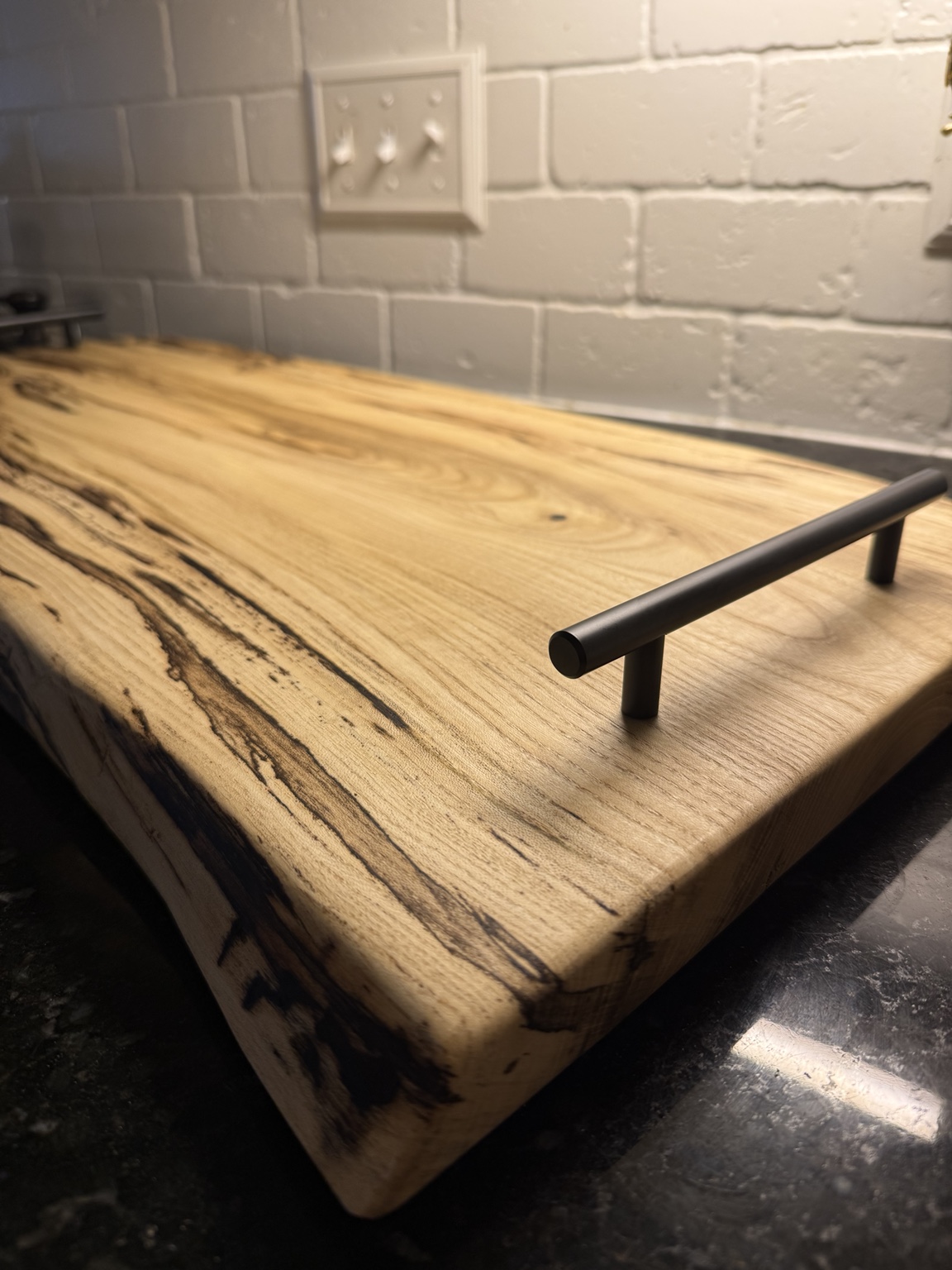 Close-up of handcrafted serving tray grain and handle